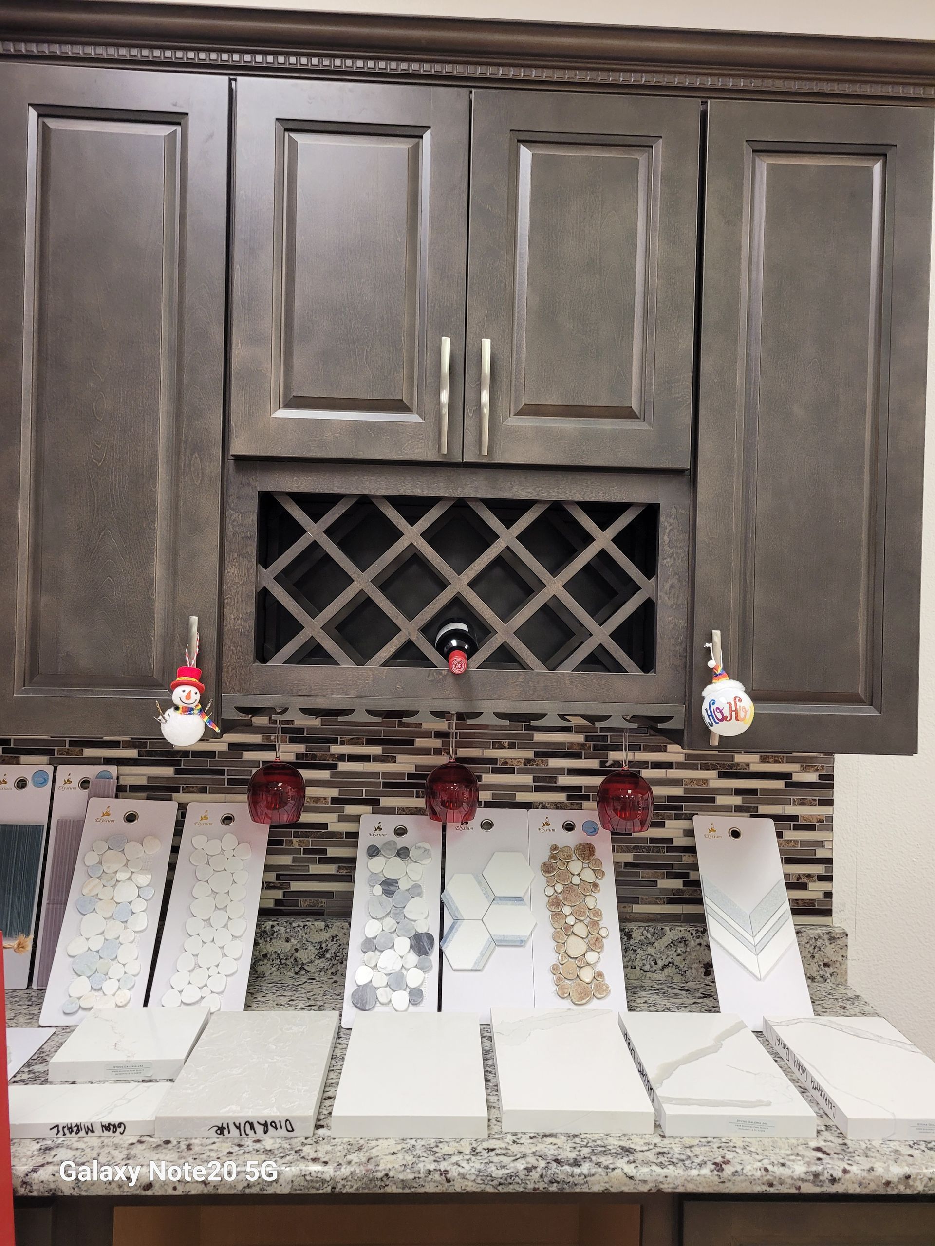 A kitchen with a wine rack above the cabinets