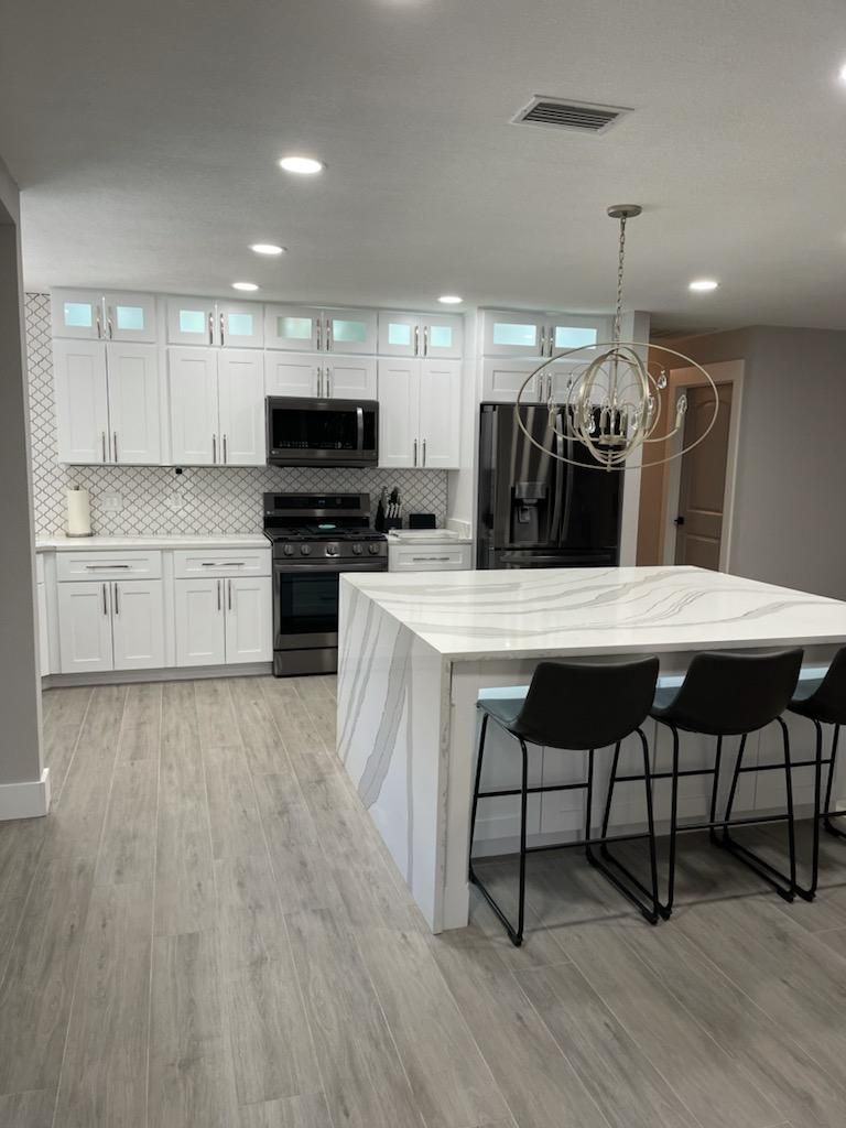 There is a large island in the middle of the kitchen.