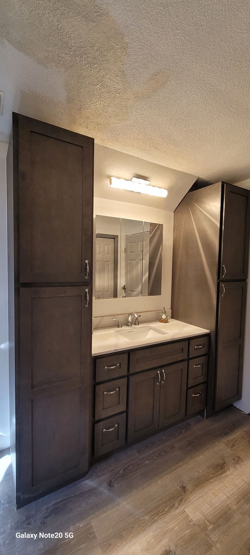 A bathroom with two sinks and a large mirror.