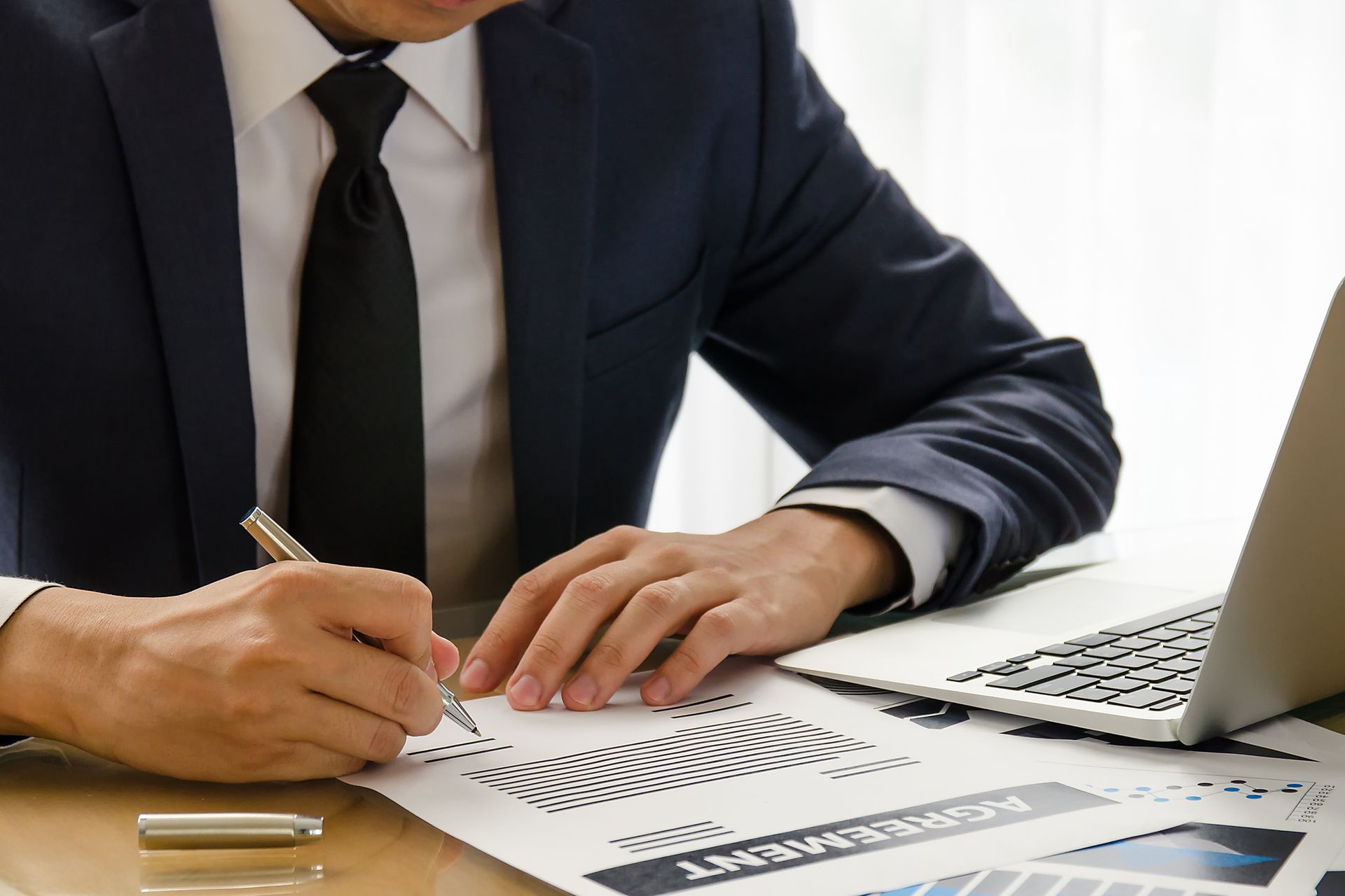 Close-up of lawyer signing contract, showcasing estate planning services, ensuring client trust. Close-up of lawyer signing contract, showcasing estate planning services, ensuring client trust.