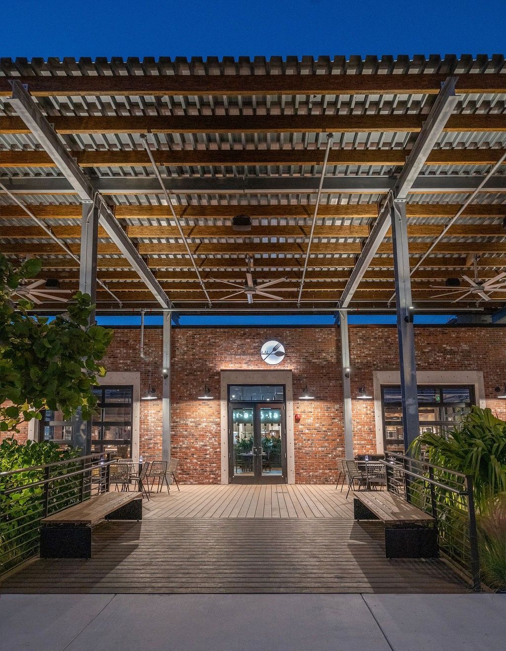 A brick building with a wooden deck and a wooden roof.