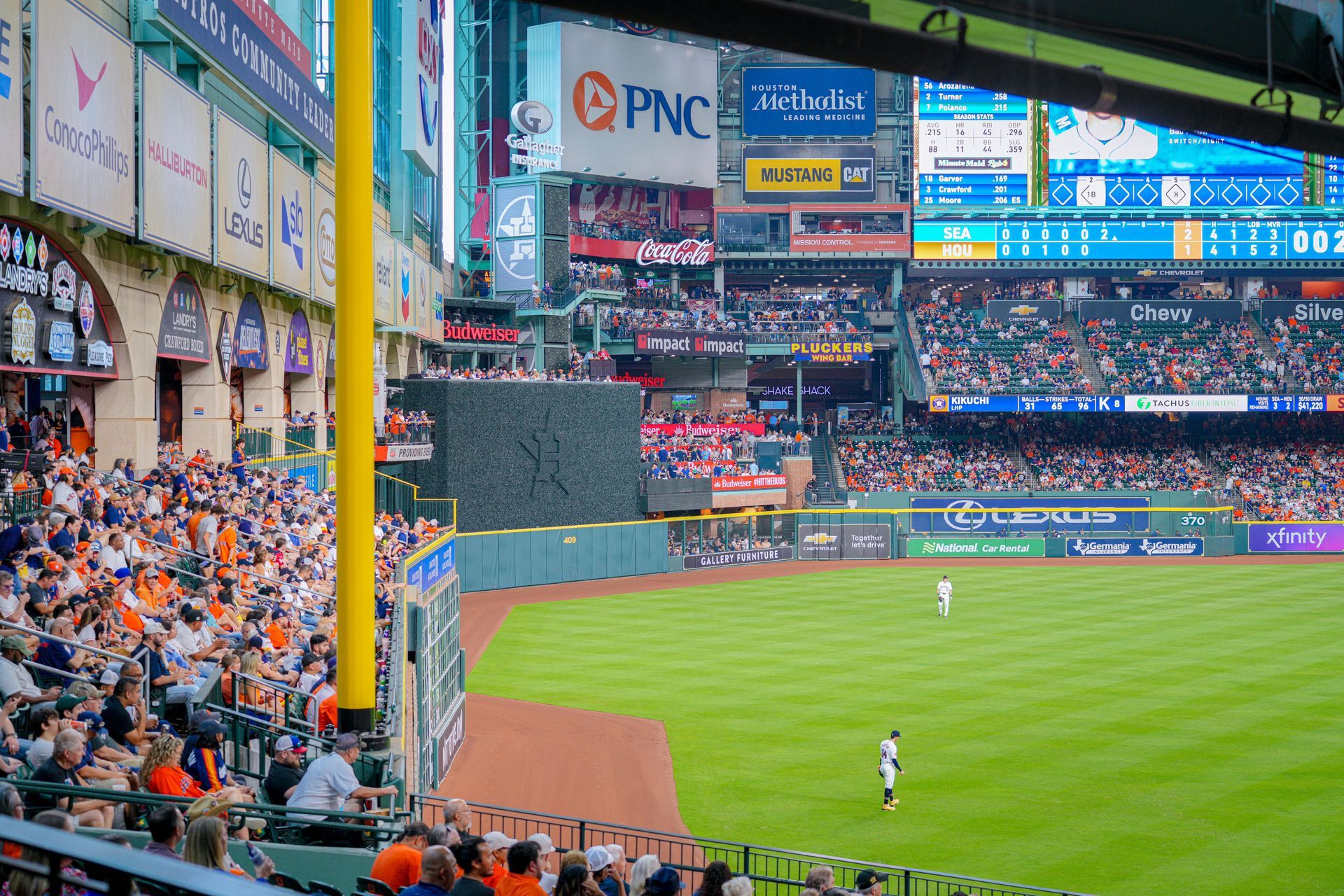 A baseball game is being played in a stadium filled with people.
