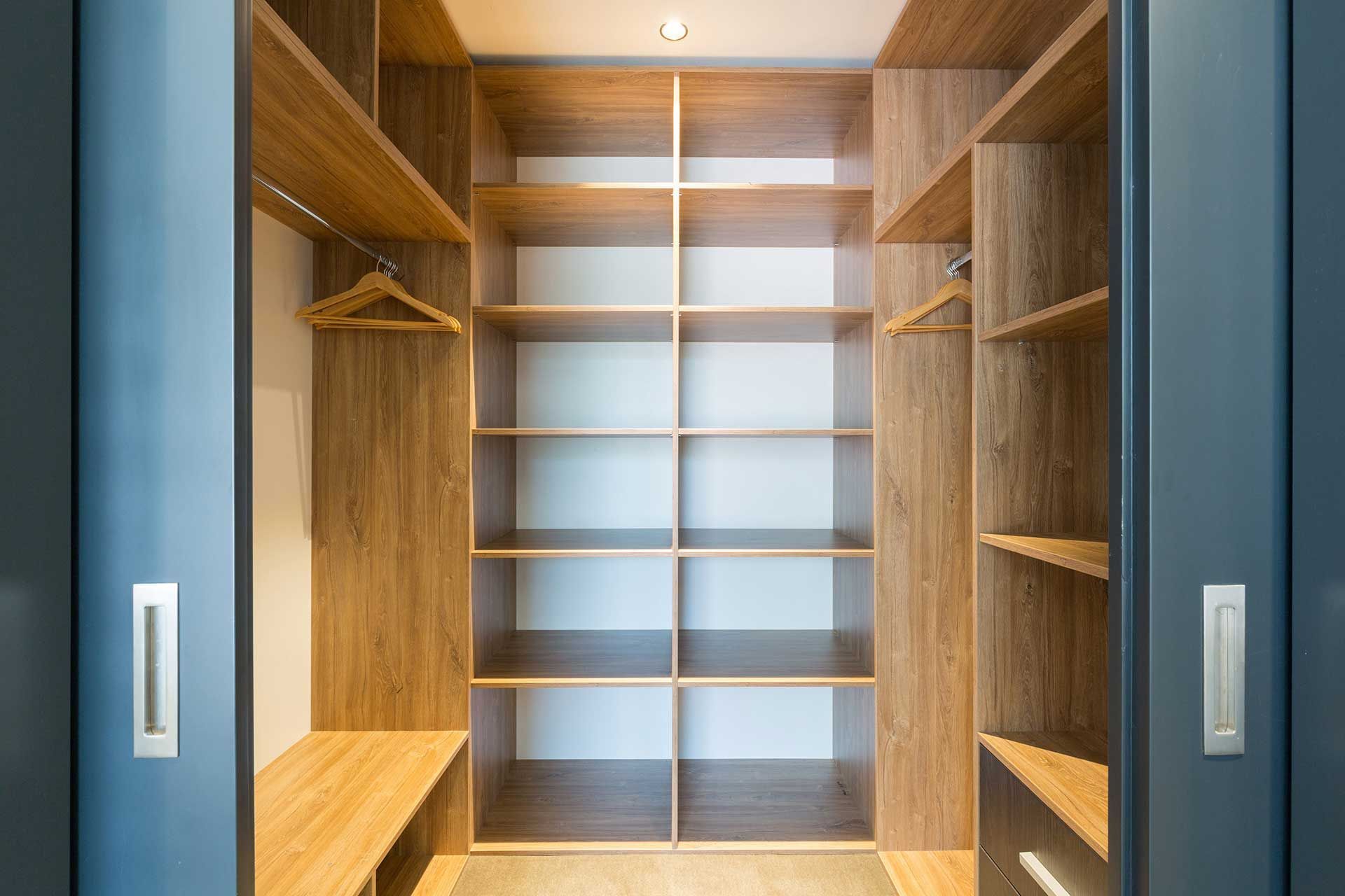 Empty storage room wardrobe cloakroom interior organization with shelving, hanging rails and shoe racks