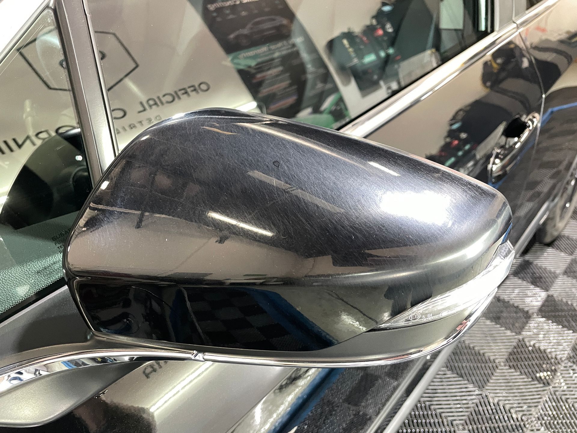 A close up of a side view mirror on a car.