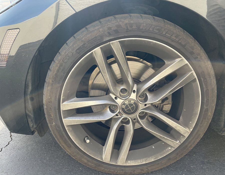 A close up of a car wheel with a tire on it