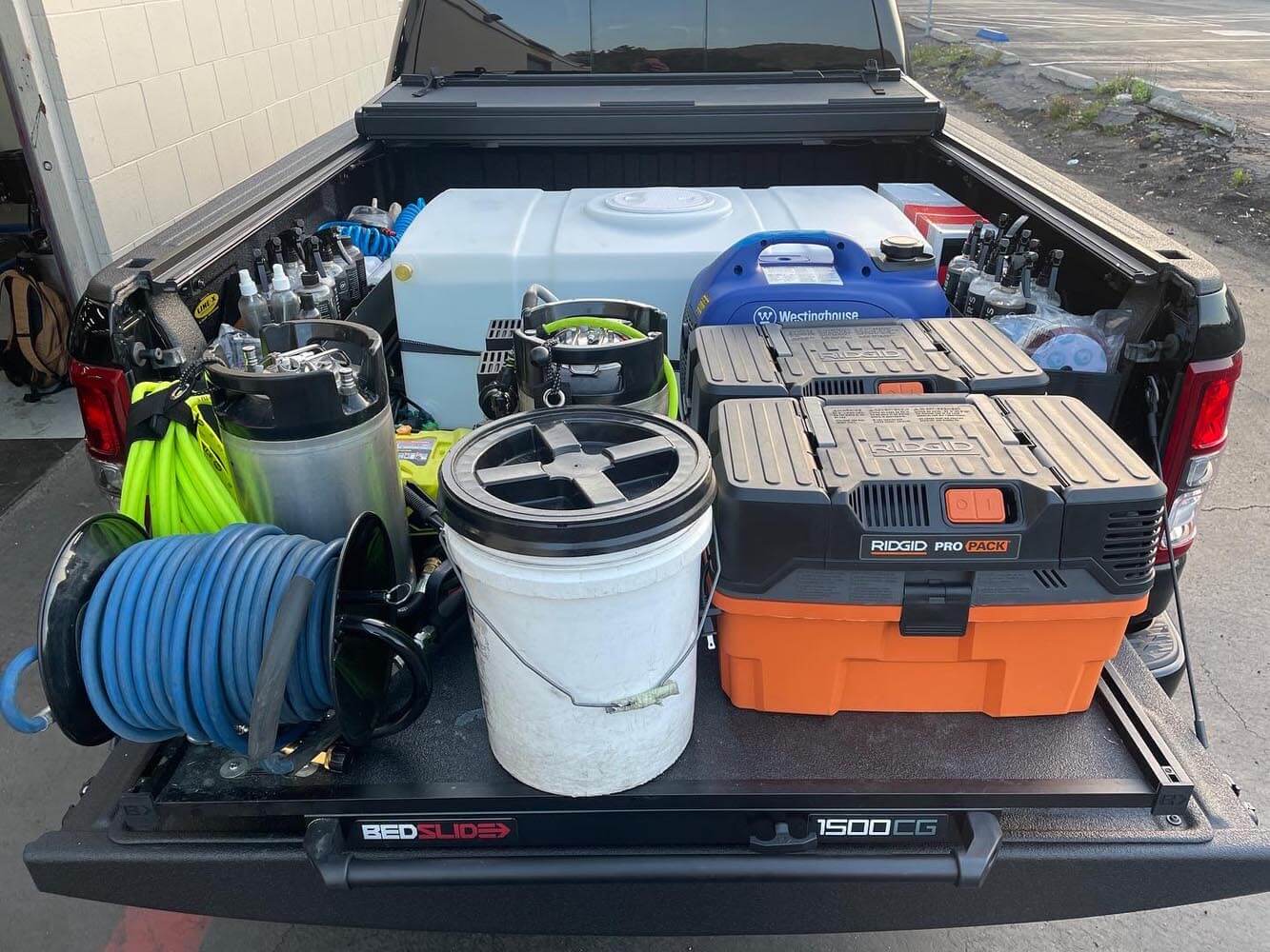 The back of a truck is filled with tools and equipment.