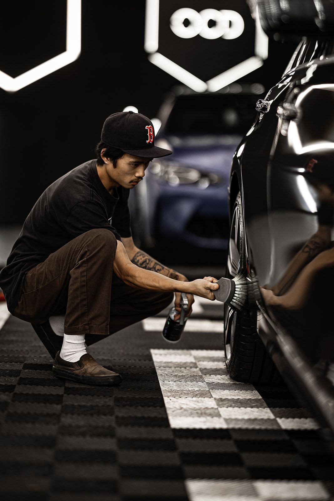 A car is sitting in a garage with its doors open.