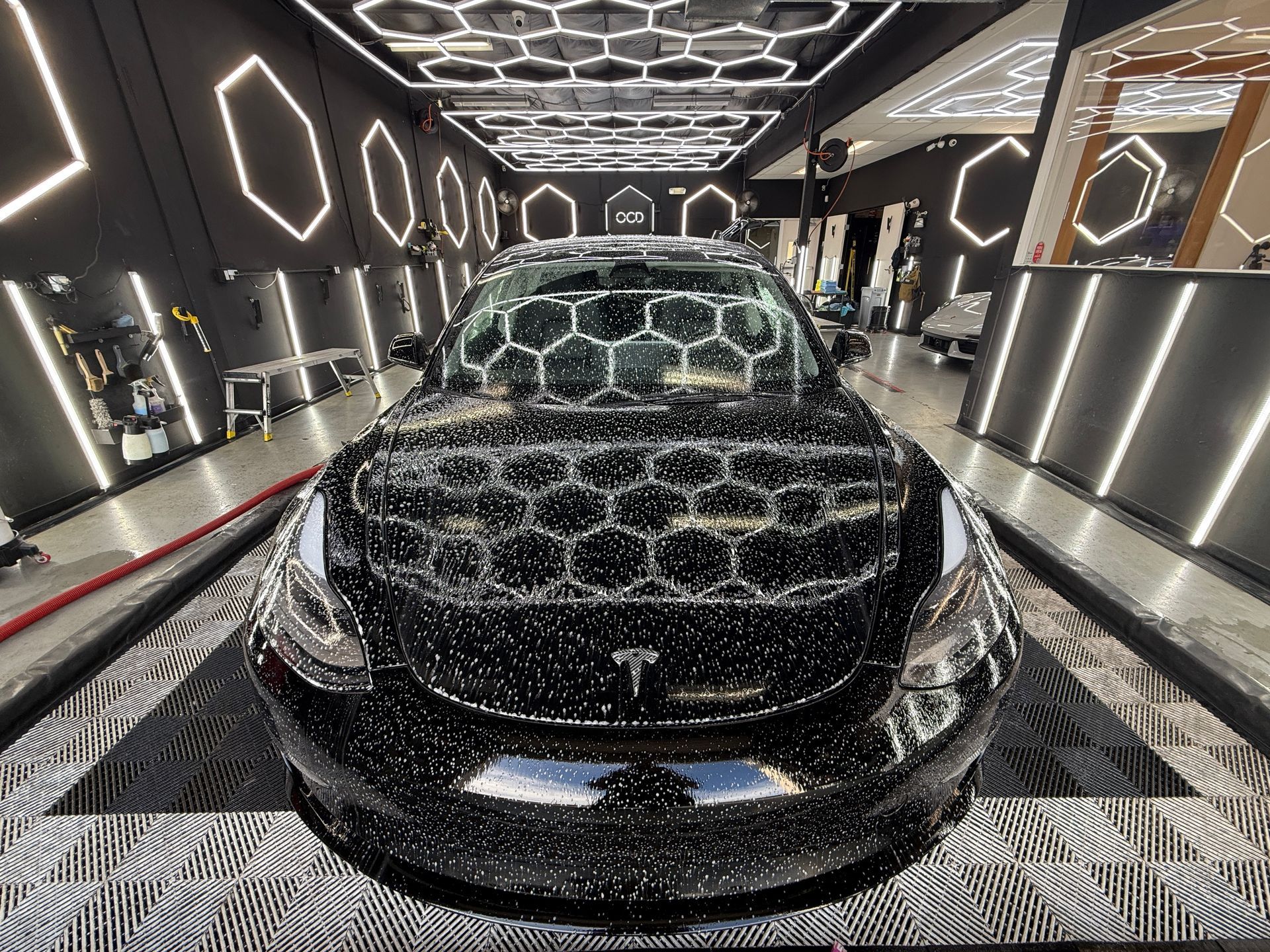 A silver sports car is parked in a garage.