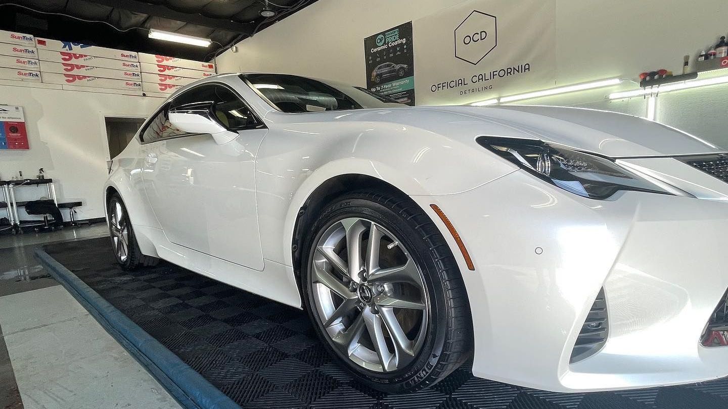 Car fully wrapped with paint protection film in a detailing garage
