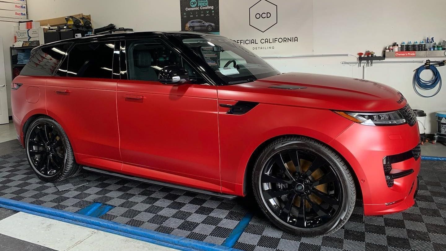 Red car with full PPF in a professional auto detailing shop