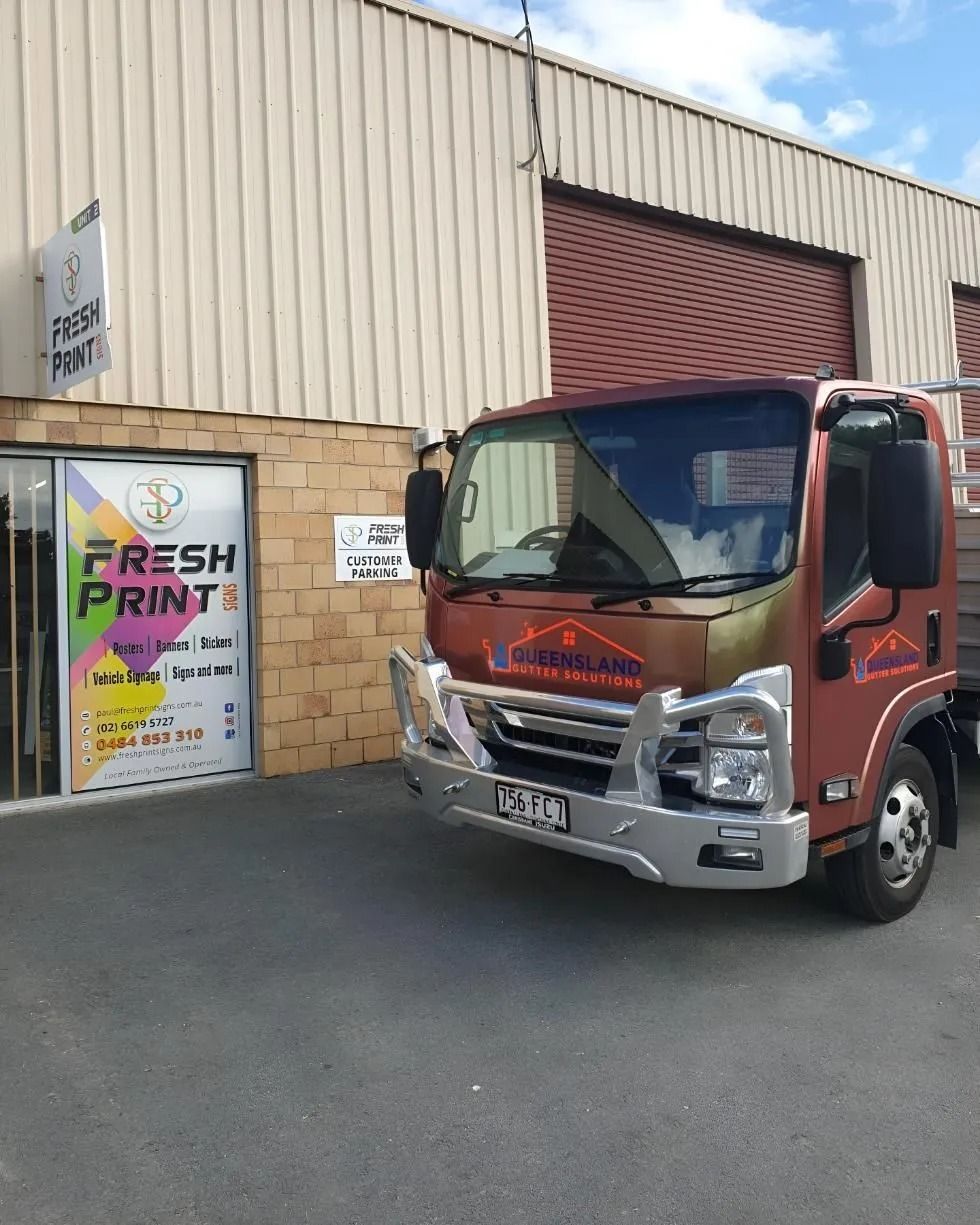 A Red Truck is Parked in Front of a Building — Fresh Print Signs in Murwillumbah, NSW