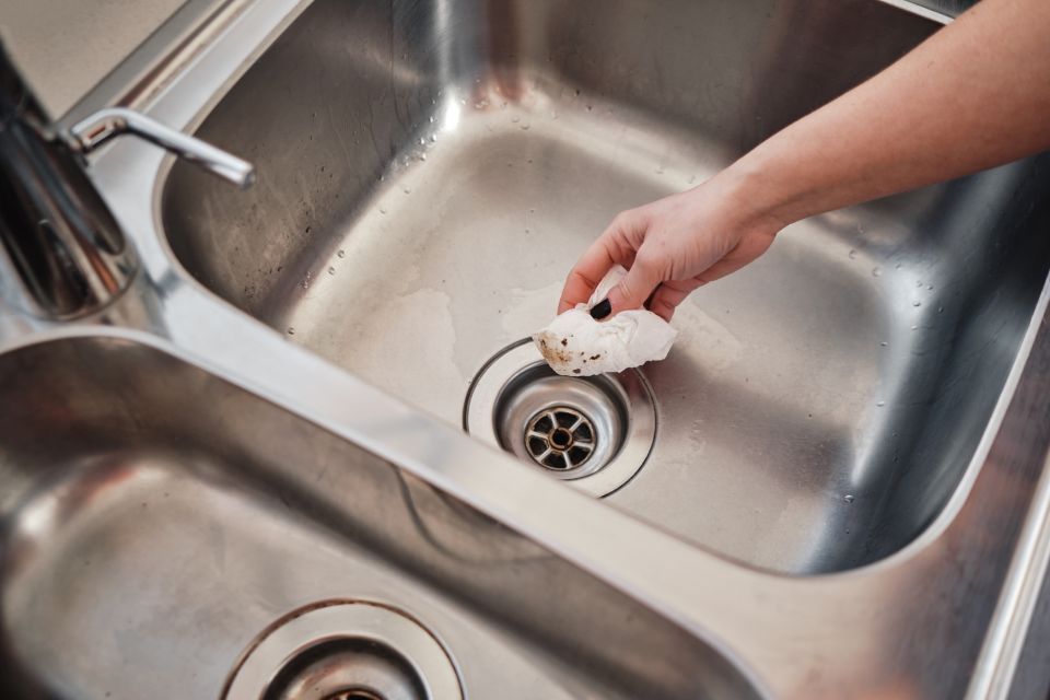 woman cleans kitchen sink