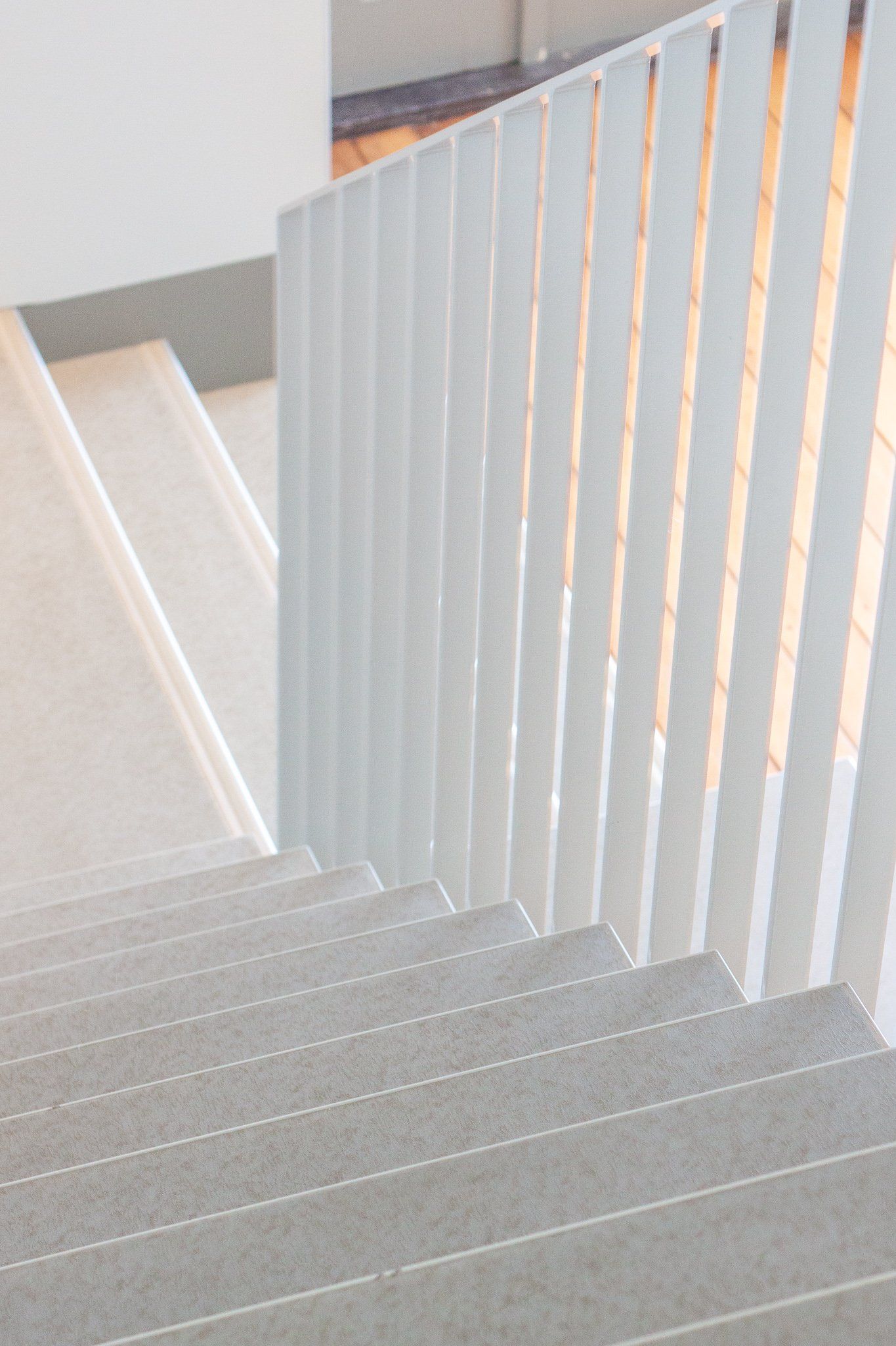 Een trap met een witte leuning