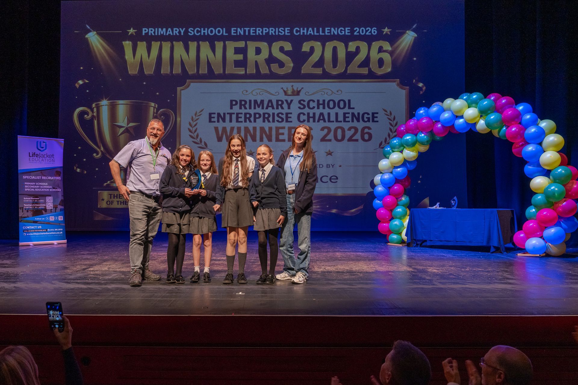 Primary School Enterprise Challenge Ambispace 2026 Finals Winners Burton Road Primary School Barnsley Sensory Room Design Prize Kevin Wheatley presents to grand final trophy to Burton Road Primary School Cozy Corner Students