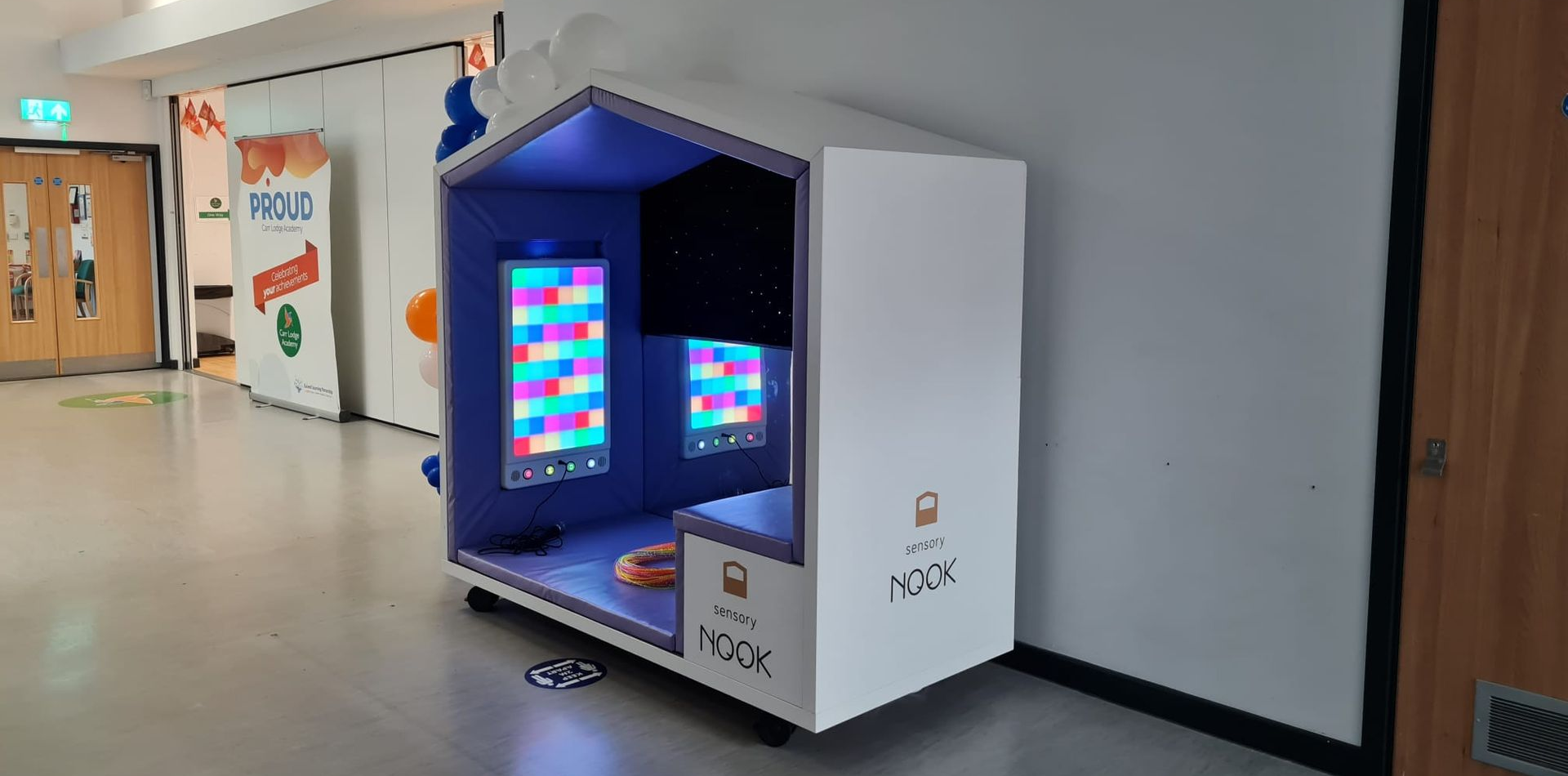 Sensory Nook Interactive situated in a corridor with a sound-to-light rhapsody panel inside