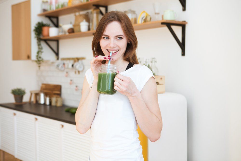 Woman Drinking Green Juice — Chicago, IL — Southtown Health Foods