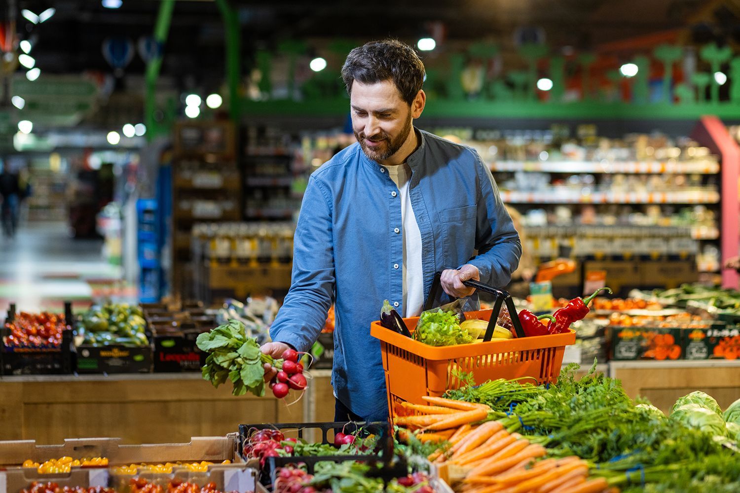 A man is selecting fresh vegetables.