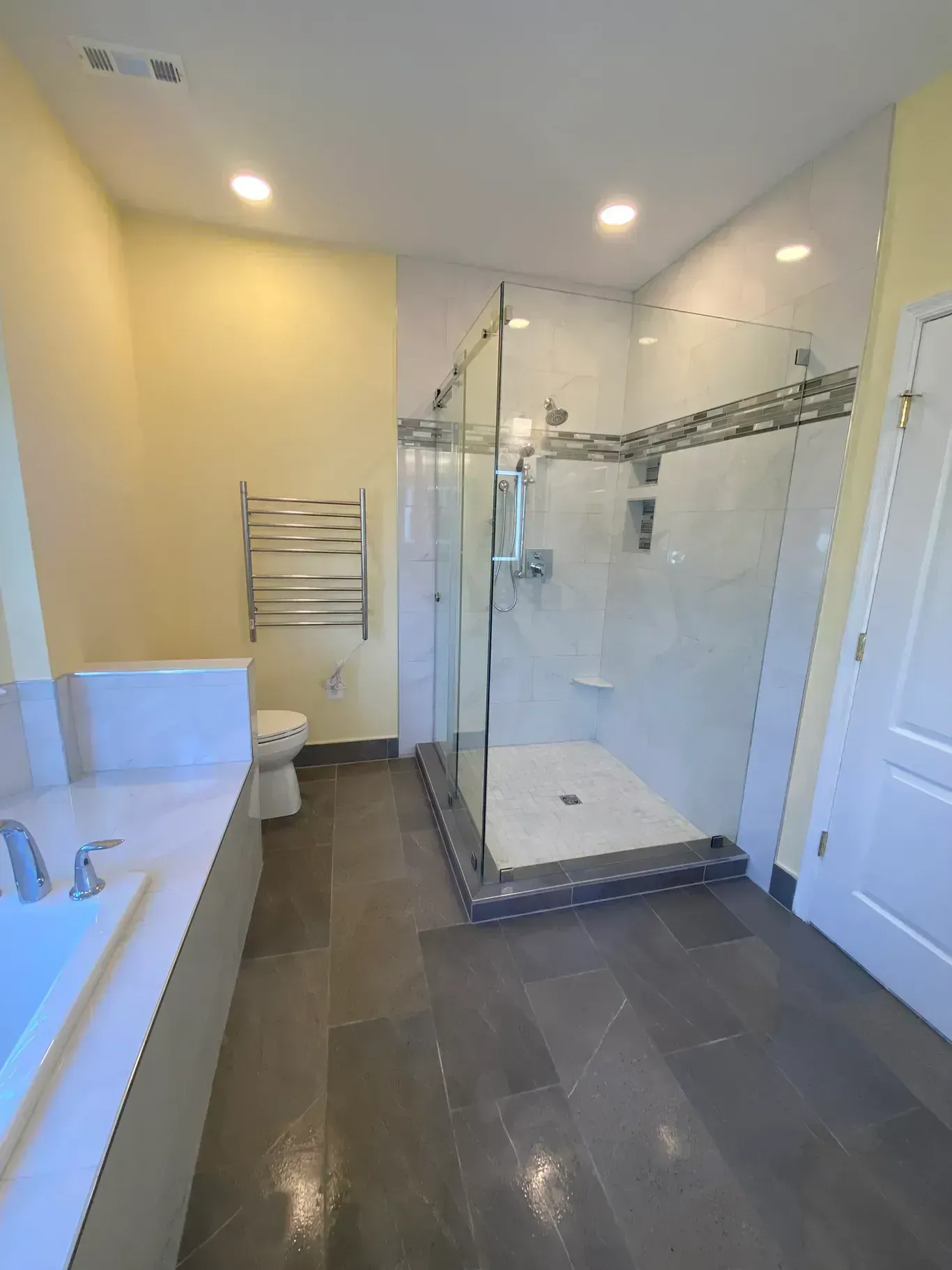A bathroom with a walk in shower and a toilet.