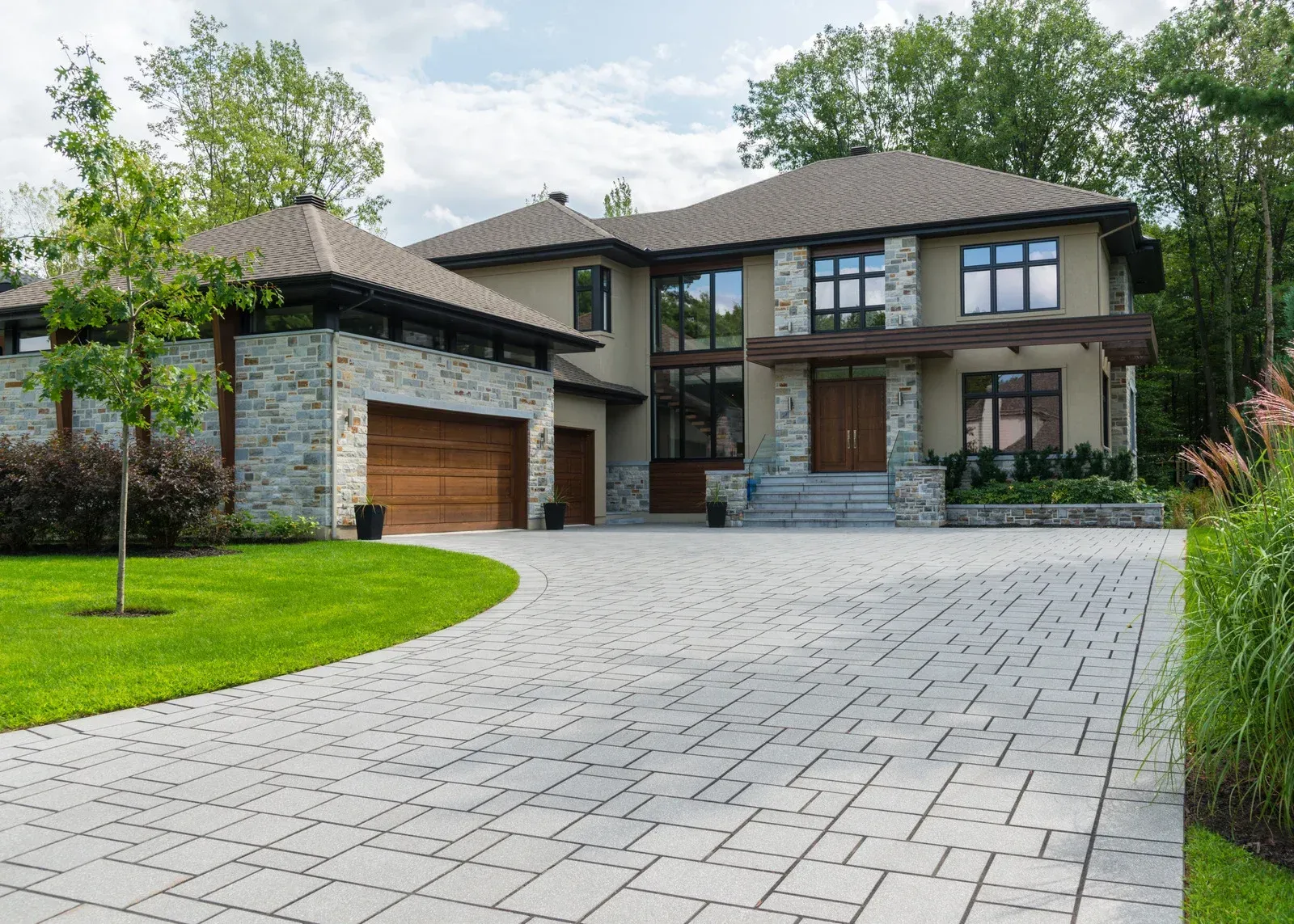 A large house with a large driveway leading to it.