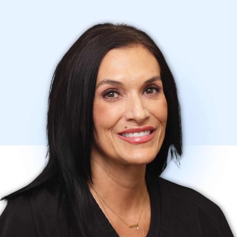 Woman with dark hair smiles; light blue gradient background.