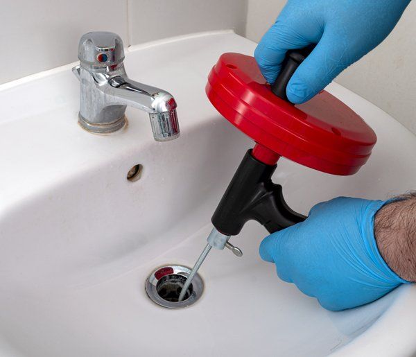 Plumber Fixing Bathroom Sink — Streamwood, IL — United States Drain & Sewer Plumbing