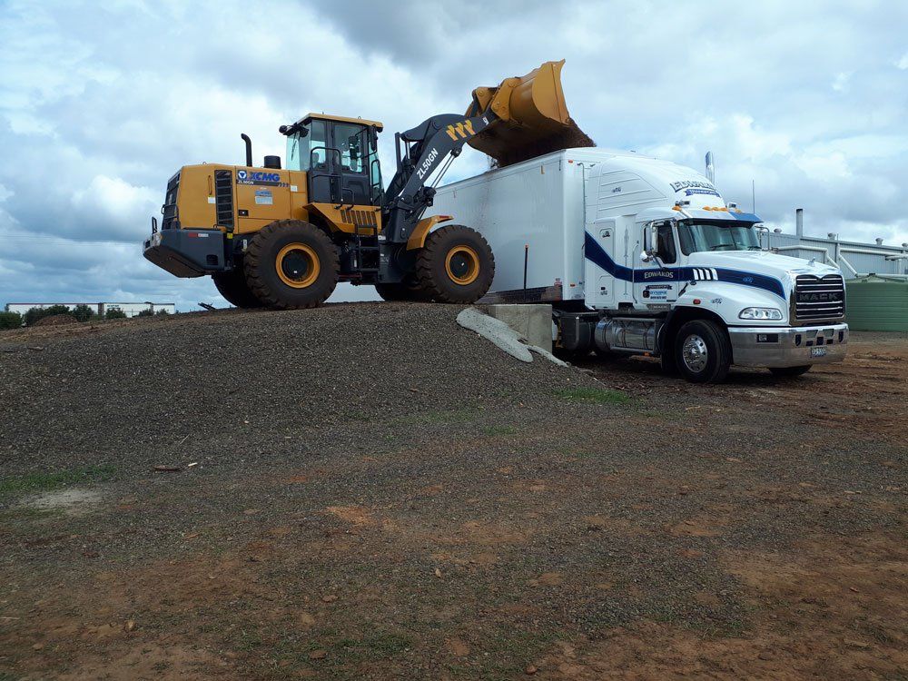 Bulldozer And Truck For Transporting Commercial Goods — Edwards Transport, Cartage & Haulage in Gympie, QLD