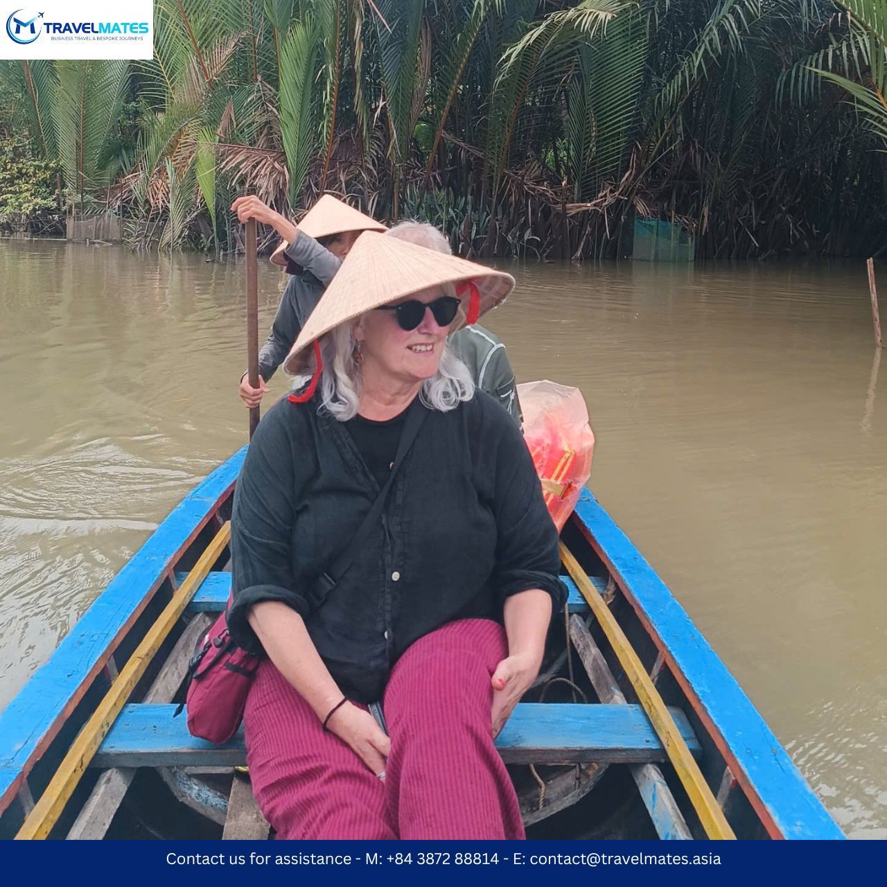Visitors boarding a traditional wooden boat in Mekong Delta tour