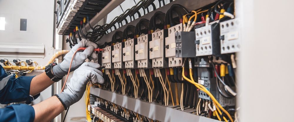 Technician Wiring an Electrical Control Panel With Organized Cables — Diverse Power In Berkeley Vale, NSW