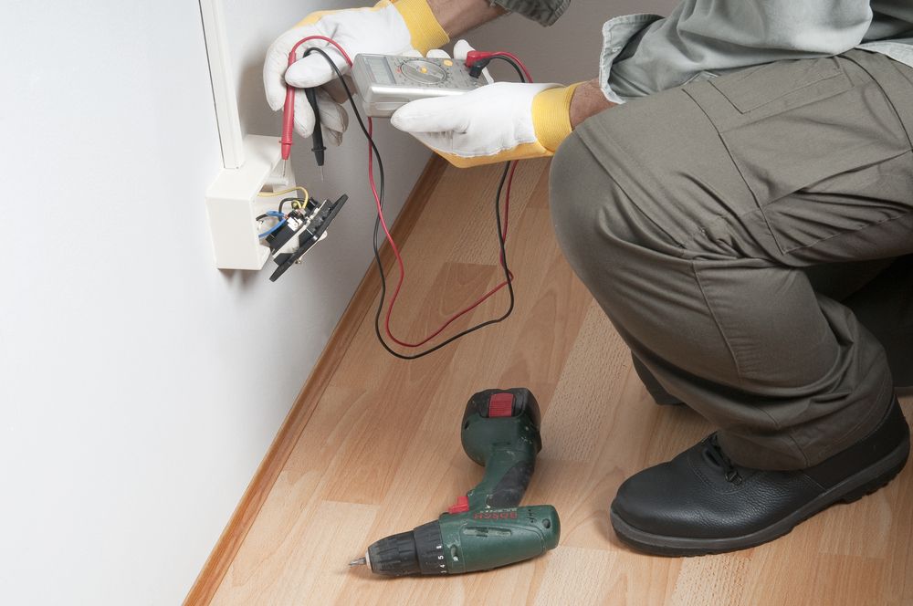 Person in Gloves Repairing Wall Wiring — Diverse Power In Lake Macquarie, NSW