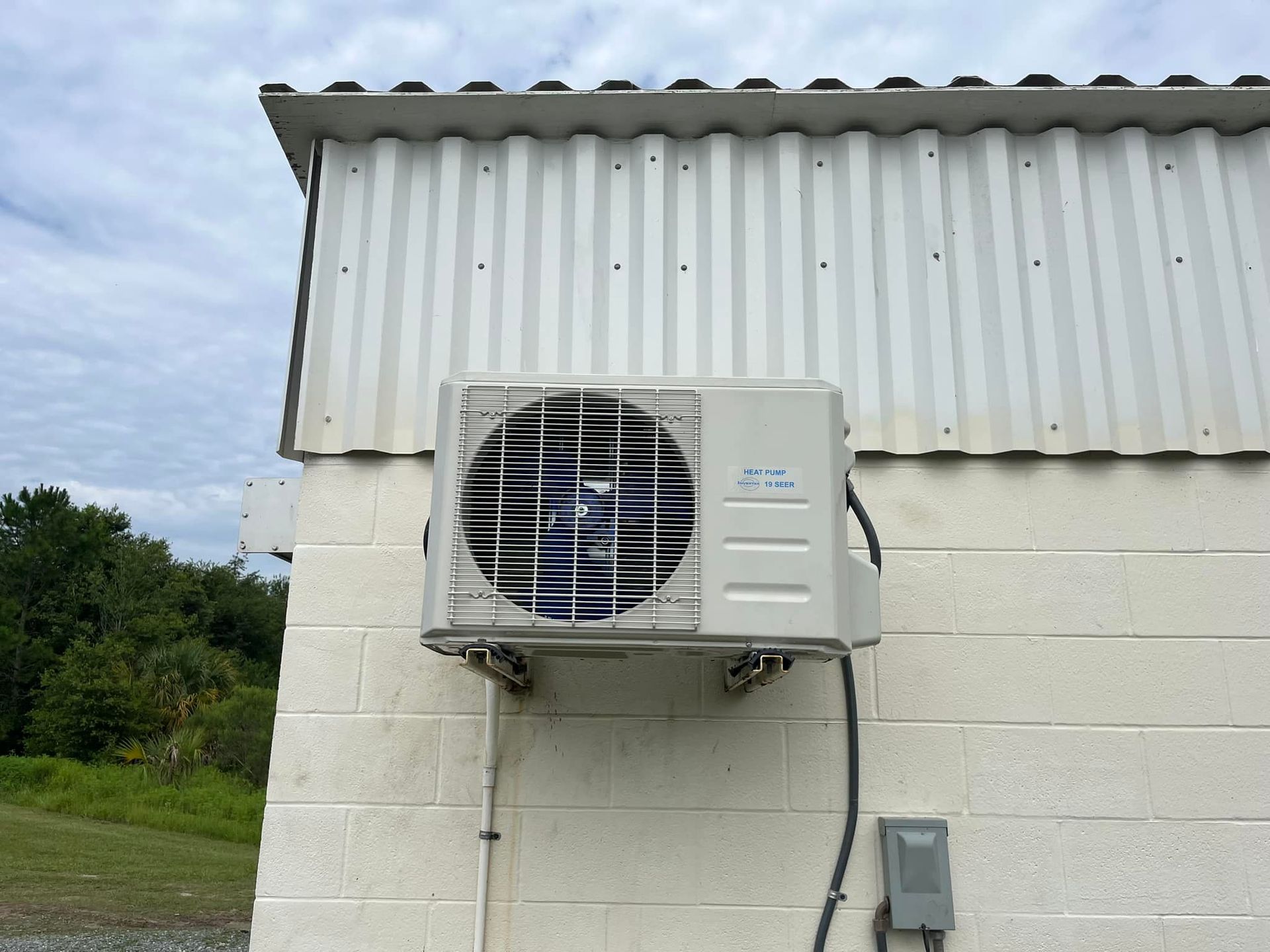 An air conditioner is mounted on the side of a building.