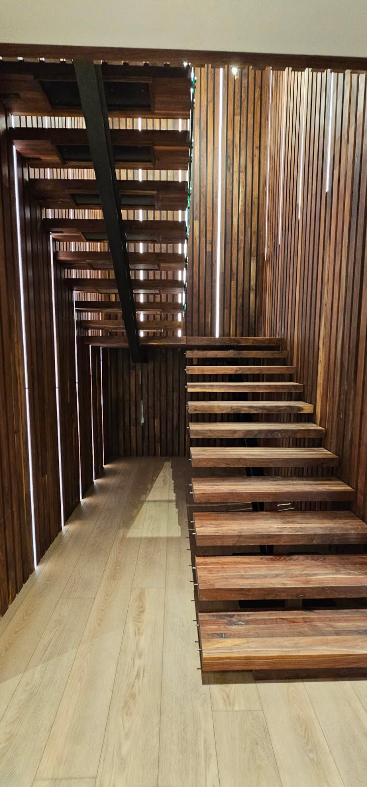 A wooden staircase with a wooden wall behind it