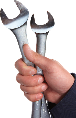 Hand holding two silver wrenches. | Royal Automotive Repair