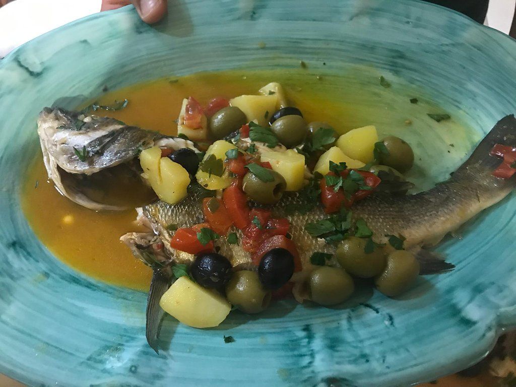Fresh fish with potatoes and olives