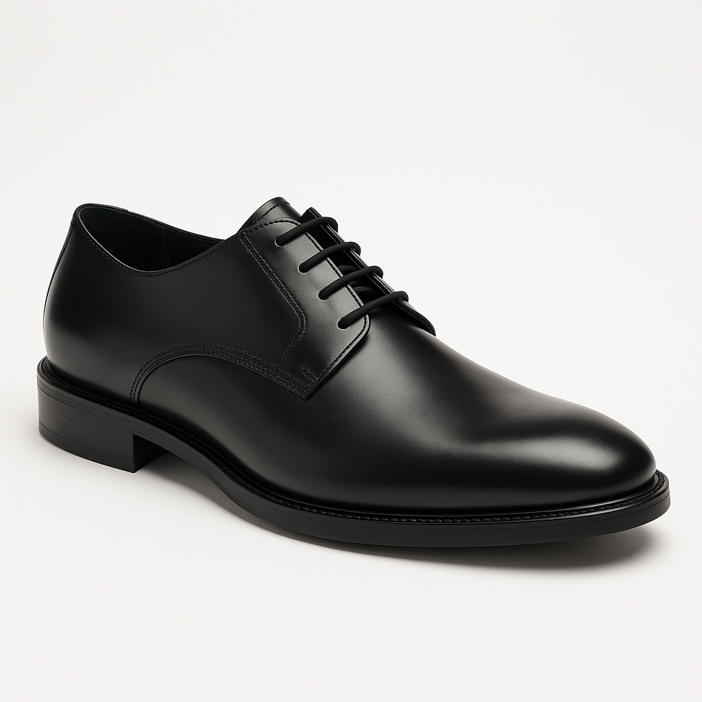 A pair of black lace up shoes on a white background