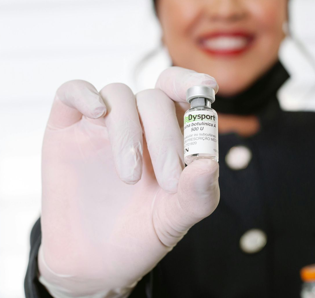 Nurse practitioner holding a vial or neurotoxin treatment.