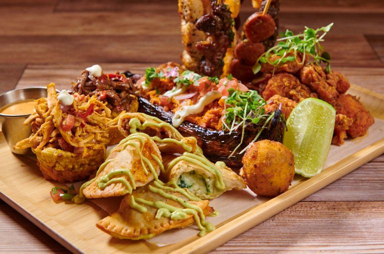 Large platter with assorted fried and grilled Latin American appetizers.
