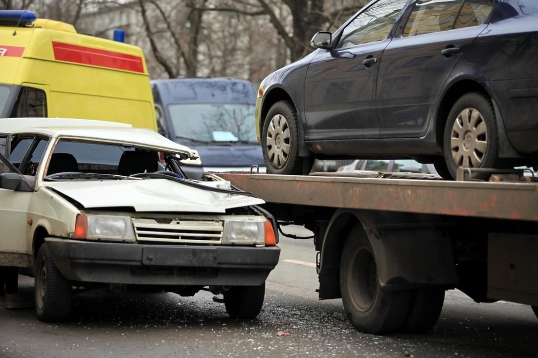 A car is being towed by a tow truck.