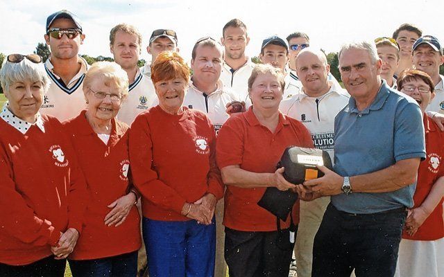 Heartbeat members presenting a defibrillator to Norden Cricket Club