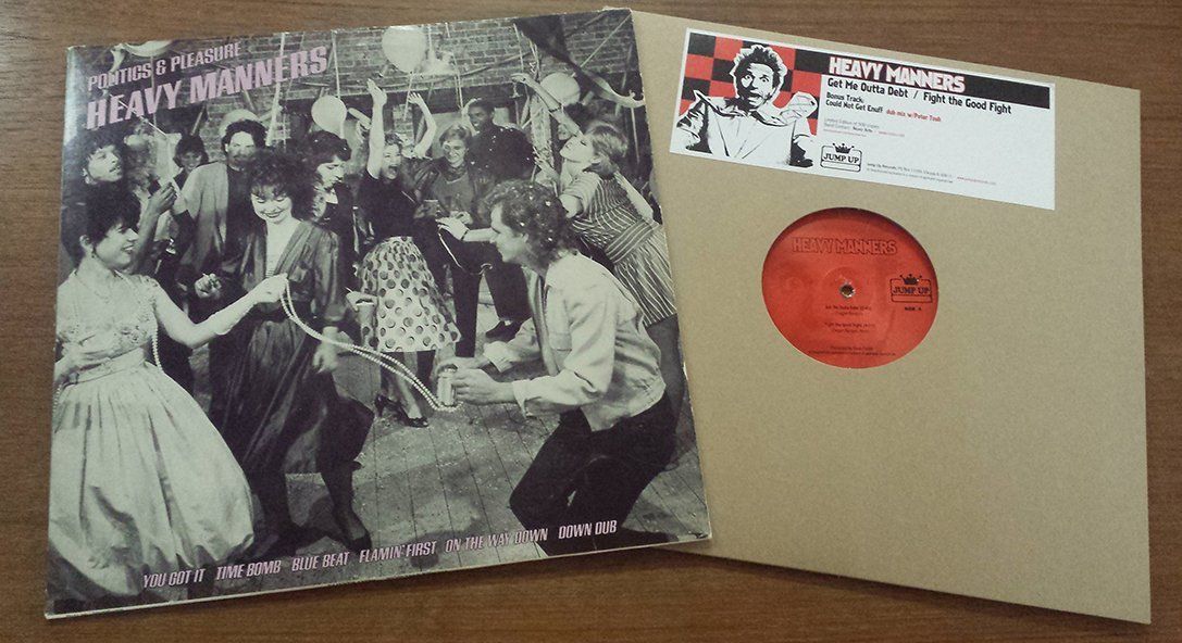 A picture of a group of people dancing next to a record