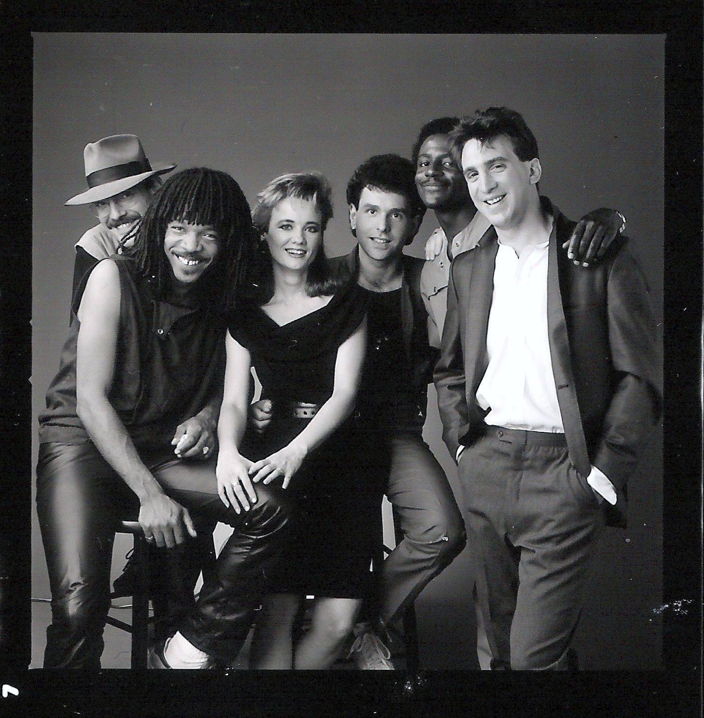 A black and white photo of a group of people posing for a picture
