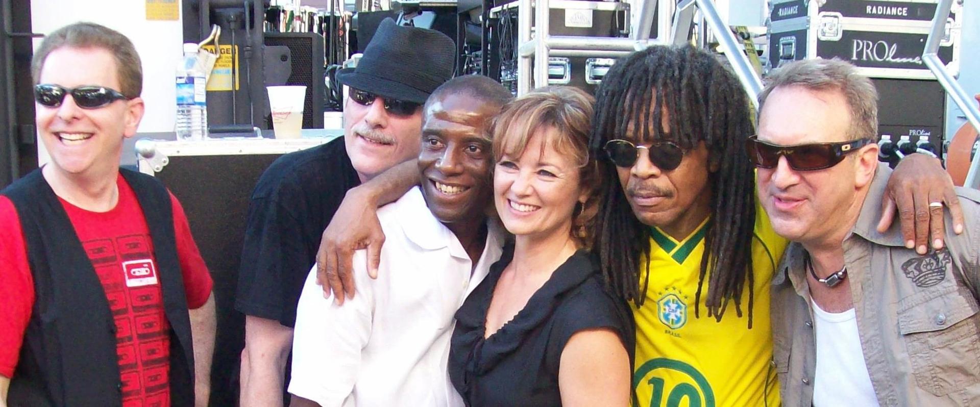 A group of people posing for a picture with one wearing a yellow shirt with the number 10 on it