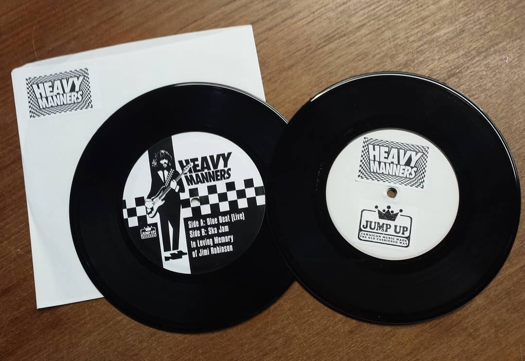 Two heavy number records are on a wooden table