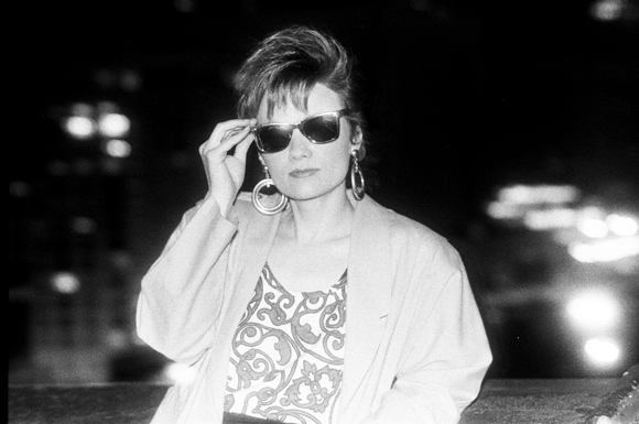 A black and white photo of a woman wearing sunglasses.