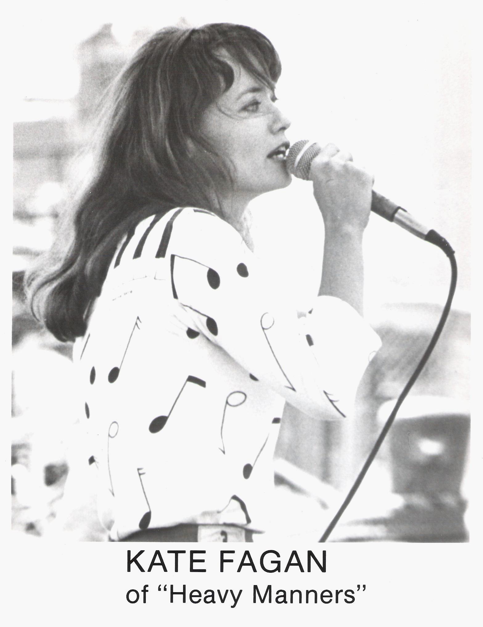 A black and white photo of a woman singing into a microphone