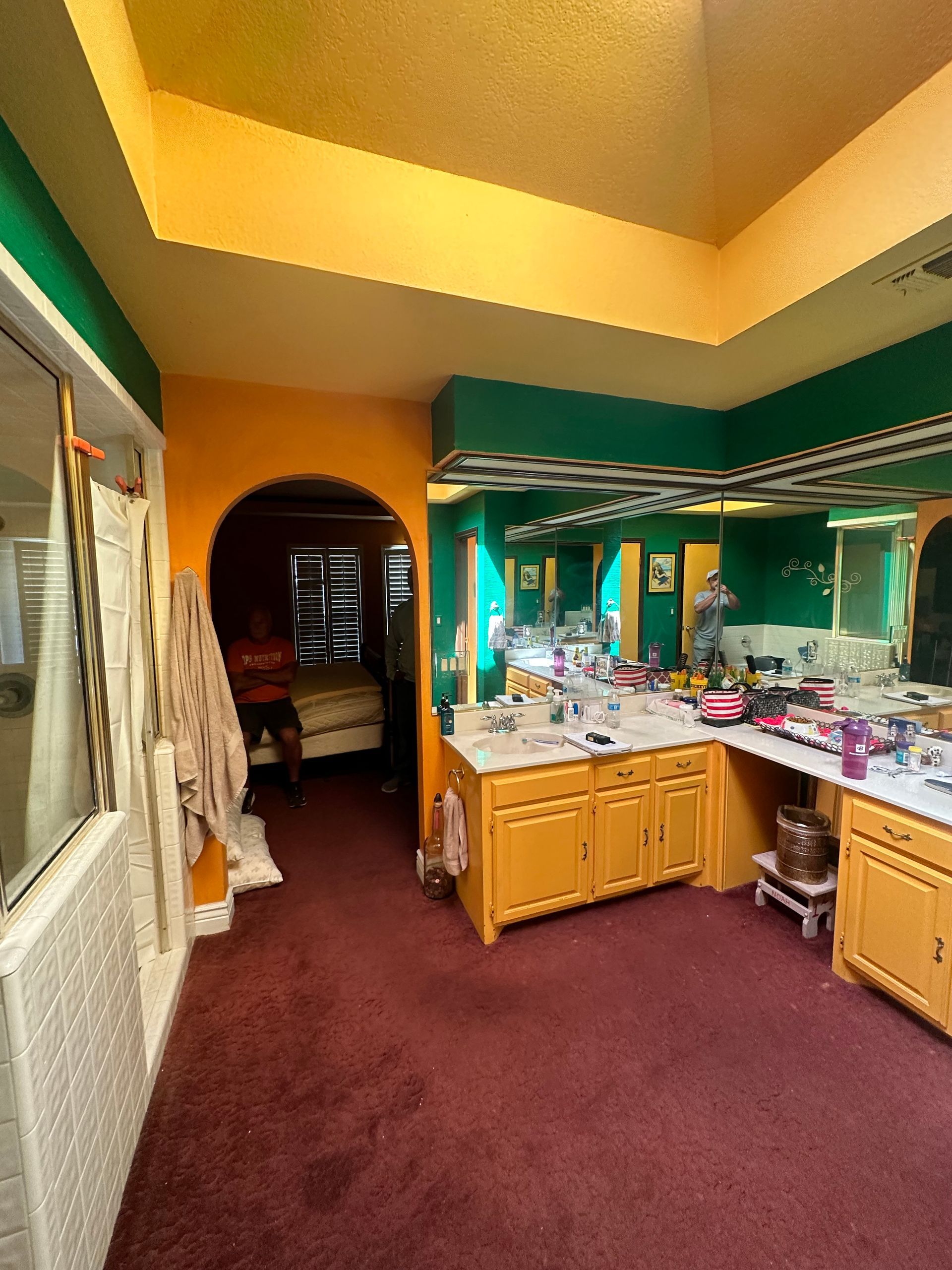 Before picture of a bathroom remodel with old cabinets  