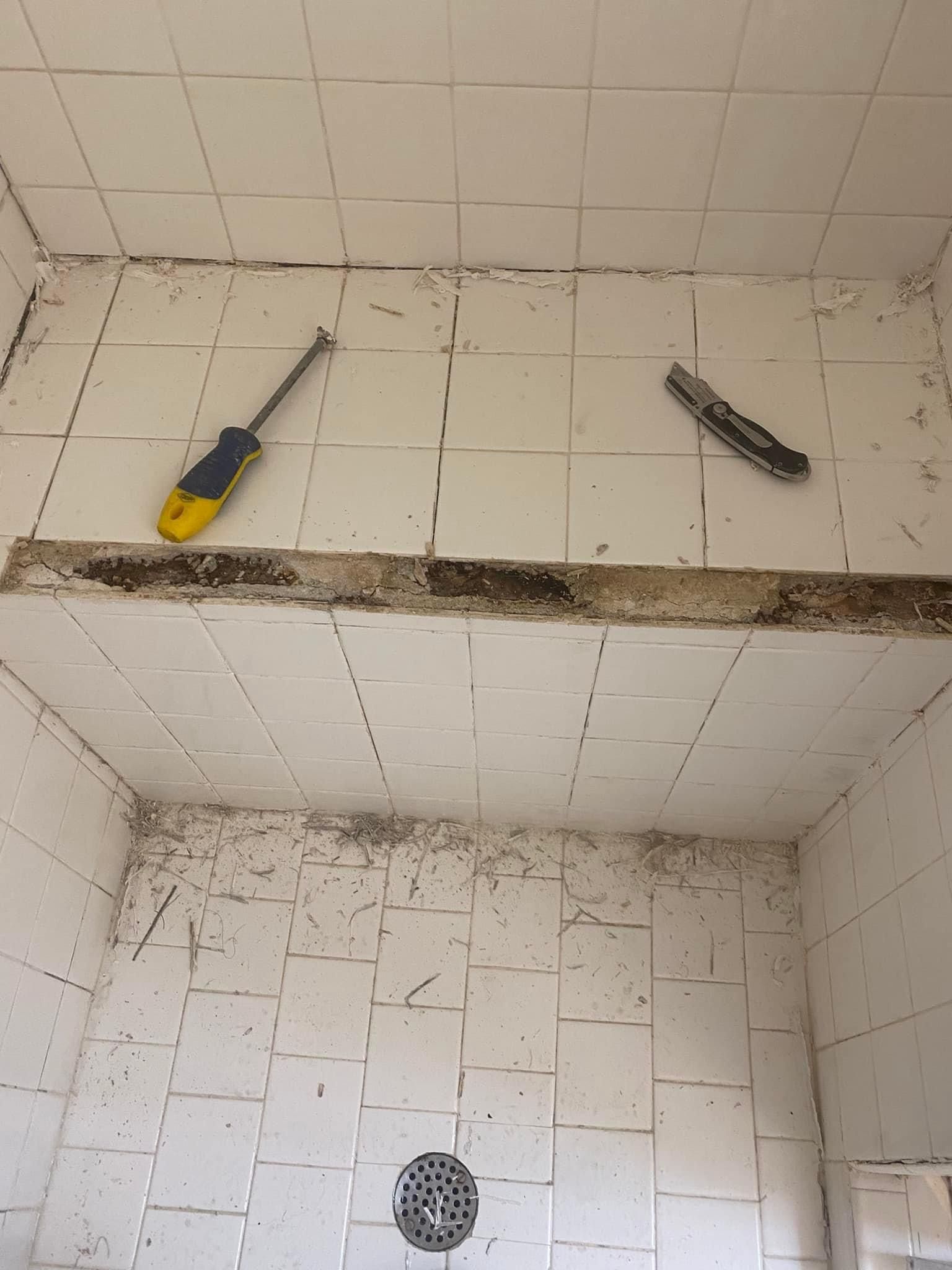 Tiled shower bench in the process of being repaired. 