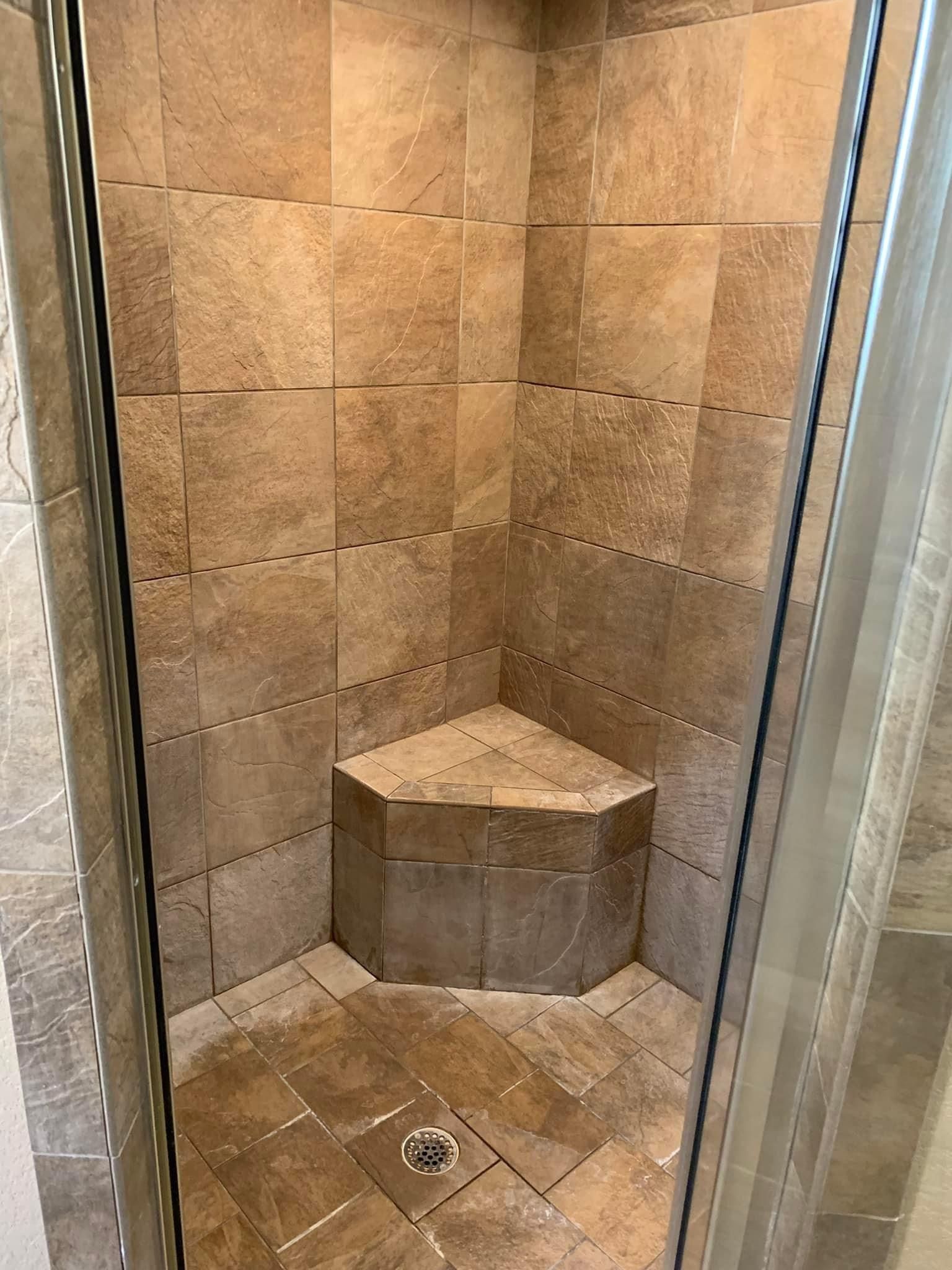 This shower has a visible build up of white mineral deposits and soap scum.  