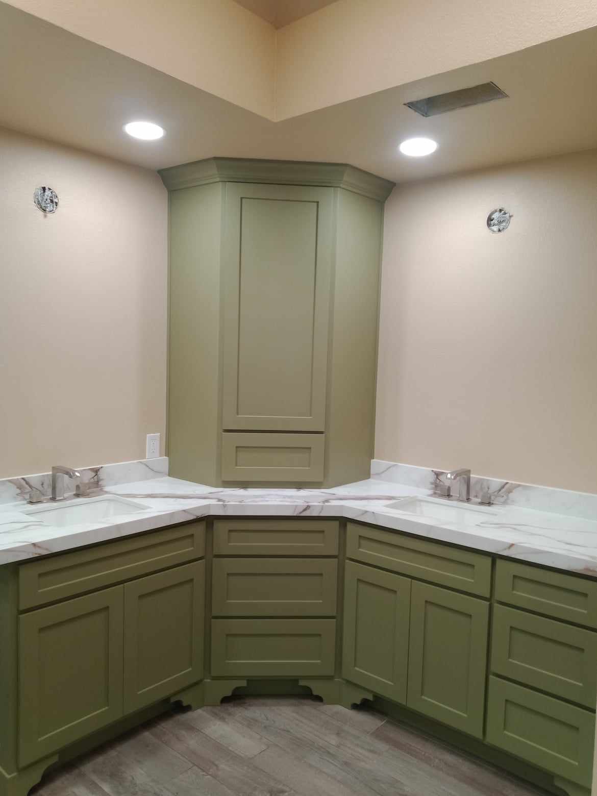 After picture of a bathroom remodel with new cabinets and a modern paint scheme   