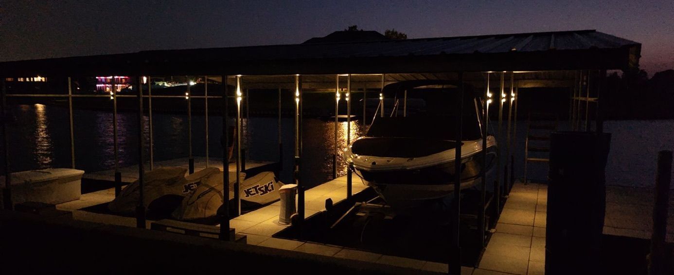 A boat is docked in a dock at night.