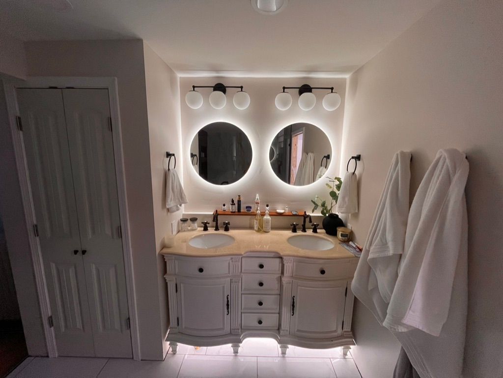 A bathroom with two sinks and two mirrors.